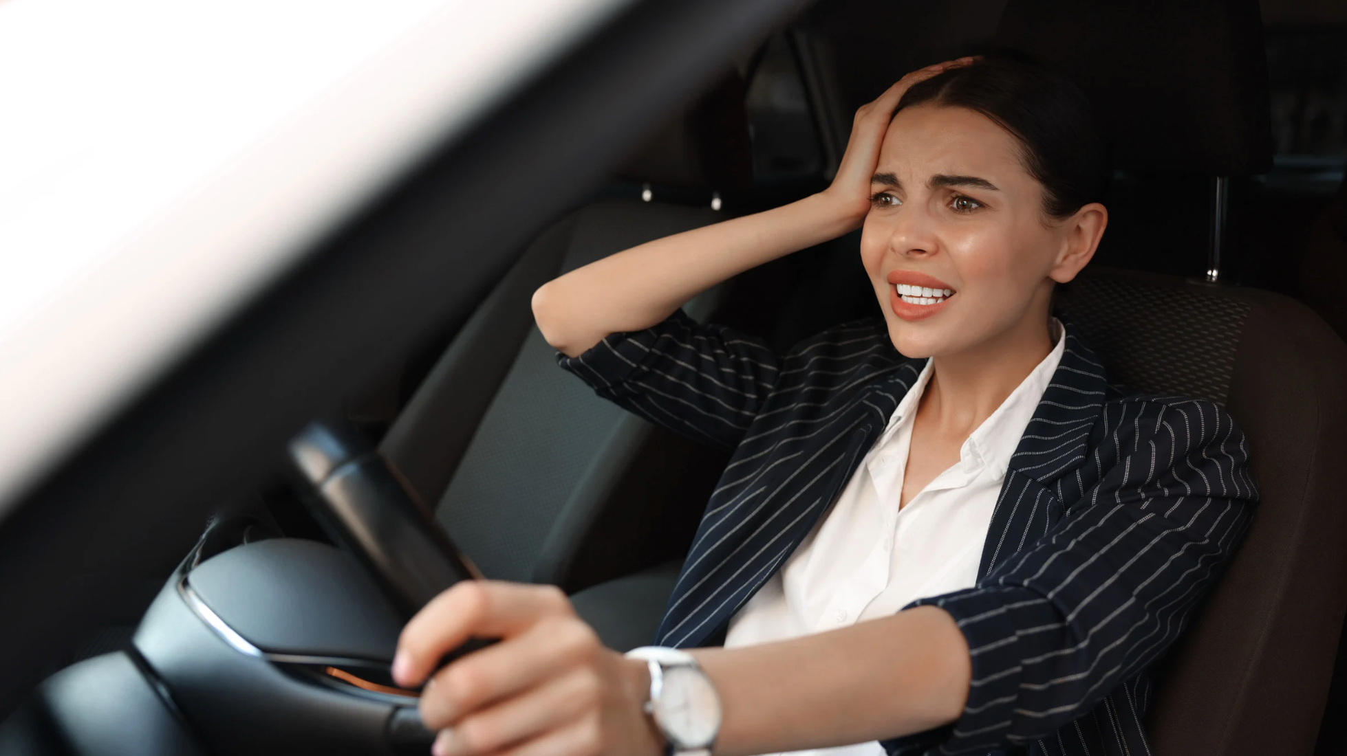 Motorista com uma das mãos na cabeça aflita por ter esquecido do dia do rodízio SP.